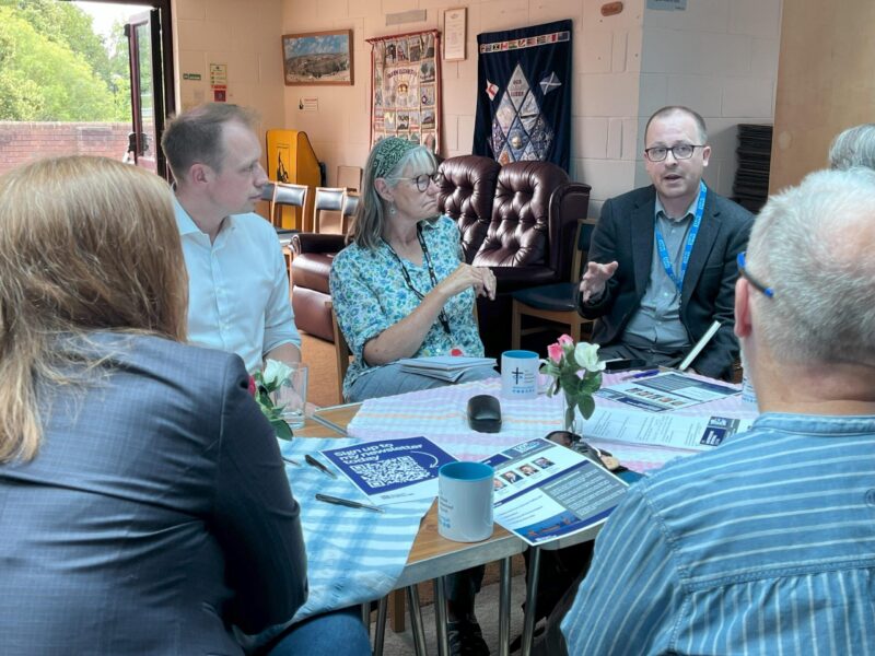 Darren with NHS Rep at Coffee Morning listening to residents.